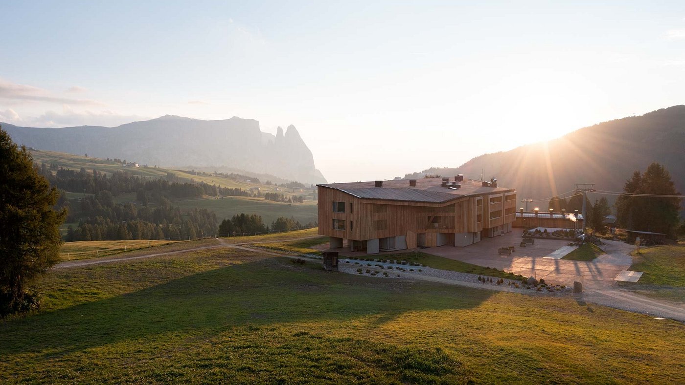 The Icaro Hotel on the Alpe di Siusi at golden hour, the Sciliar behind